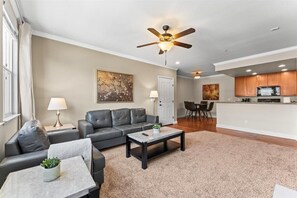 Light-filled living room with cozy seating, ideal for relaxing or movie nights.