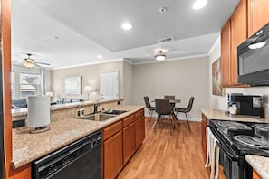Everything you need to cook and gather — fully stocked kitchen with open dining space.