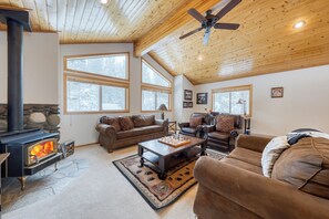 Living room with rustic decor and a stone fireplace.