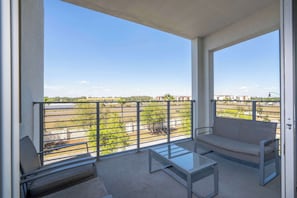 Balcony seating area with window & glass door: Chillin' spot unlocked. Natural light, comfy chairs, and the perfect vibe for your morning brew or a sunset scroll.