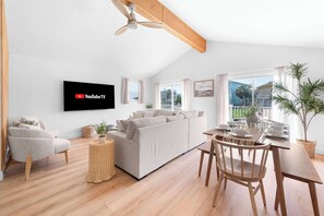 Open concept living in the upper unit. Dining, living and kitchen are in one large space. 50" smart TV. Board games. Two sliding glass door options take you to the 2nd level deck where you can relax, socialize, and dine.