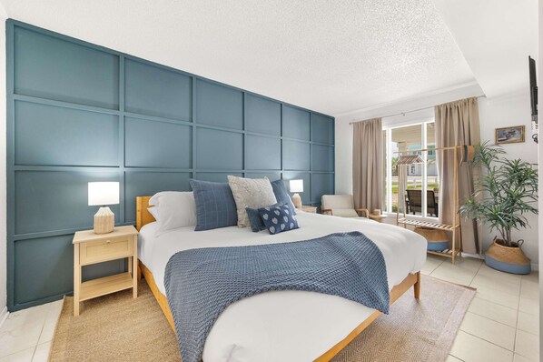 King bedroom with 50" smart TV on the main level. No steps involved to this bedroom.