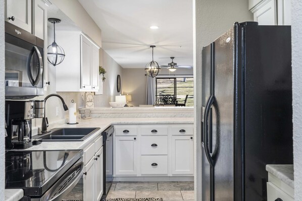 The airy, open kitchen offers ample space & every home comfort