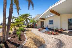 Front of house with lush landscape to admire.