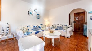 Charming living room with nautical touches, ideal for unwinding after a day by the water. #BeachHouseStyle #RelaxInComfort #SeasideCharm