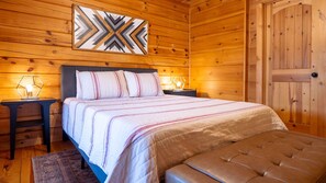 Our cozy main level bedroom features a comfortable queen-size bed and thoughtful touches for a relaxing stay.