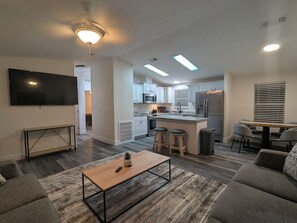 Living Area: Bright and airy space with modern decor, perfect for relaxing after beach adventures!