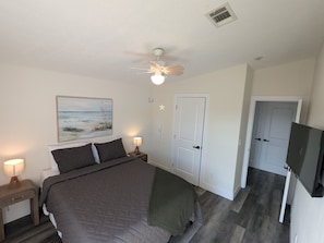 Bedroom Retreat: Bright space with seashell art and modern comforts for restful nights in paradise!