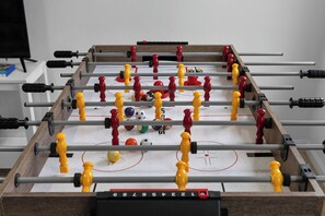 Game room fun with foosball, toys, books, board games & cozy seating. 