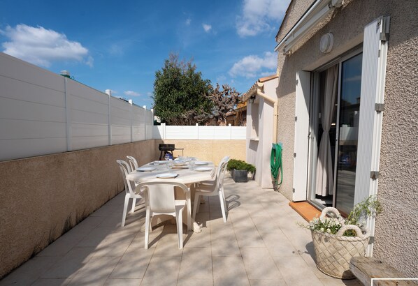 Large terrace with awning, barbecue and garden furniture