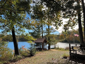 A view (summer) entering the backyard. 9 ft. gazebo right along the lakeshore.
