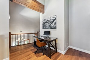 Dedicated workspace: Desk with chair, monitor and natural light, upper floor