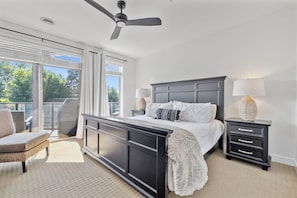 A cozy bedroom with a large bed as the centerpiece, surrounded by neutral-toned decor, nightstands, and soft lighting for a restful atmosphere.