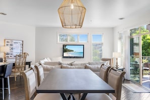 Sink into the cozy white sofa by natural light streaming in, where the space is perfect for relaxation or catching up on your favorite shows.