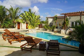 Lounge under the Aruban sun beside our crystal-clear pool—your ultimate relaxation zone.
