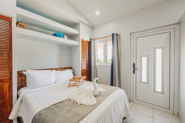 Welcome to your serene oasis—this cozy bedroom features crisp linens, natural wood accents, and soft lighting for a peaceful night’s sleep.