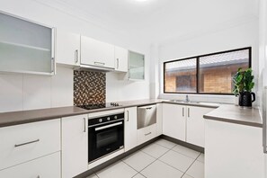 Whip up breakfast or midday snacks in the modern kitchen with spacious benches, an oven, and a dishwasher for easy clean-up.