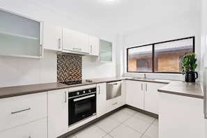 Whip up breakfast or midday snacks in the modern kitchen with spacious benches, an oven, and a dishwasher for easy clean-up.