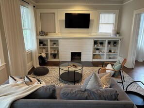 Living room w/ balcony and 55" TV. High speed wifi, up to 1 GB throughout apt.