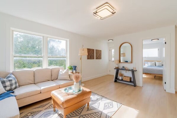 Kick back and relax in the cozy living room—plush seating, a 65” Smart TV, and a warm, inviting vibe!