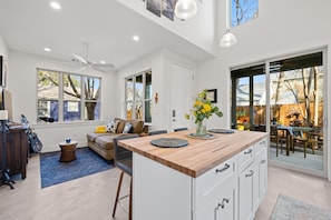 Kitchen space, high ceilings, large windows for natural light. 