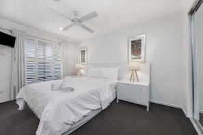 A beautiful Queen Size bedroom with a wall mounted TV for your relaxing stay.