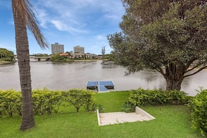 Peaceful poolside setting overlooking wide waterfront and bridge