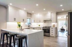 Gourmet kitchen with stainless steel stove, french-door refrigerator, dishwasher