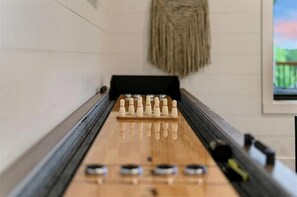 Game Room: Enjoy friendly competition with our sleek shuffleboard table and chic decor!