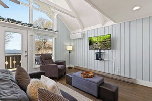 Experience the best of contemporary living in our spacious living room, featuring a cozy fireplace and complemented by a state-of-the-art TV for entertainment. Enjoy stylish comfort with stunning views in this inviting retreat.