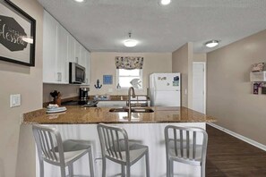 An impeccably stocked kitchen awaits, equipped with everything you need for a delightful culinary experience.