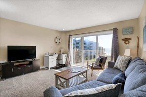 Discover the epitome of relaxation in this beachfront living room with expansive sky views, the perfect haven to unwind.