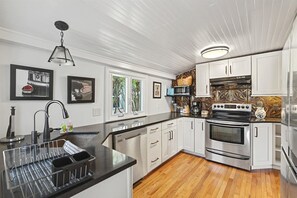 Stainless steel appliances and farmhouse touches bring both style and function to the kitchen.