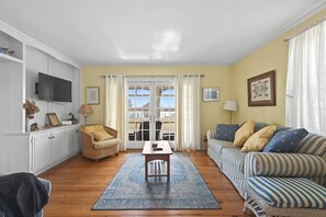 Bright and cozy living room featuring a Smart TV and comfy seating for family movie nights.
