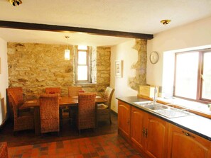 Kitchen and dining area with table and chairs
