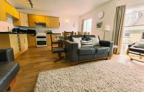 open plan living and kitchen area with dining table