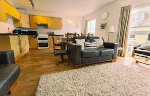 open plan living and kitchen area with dining table