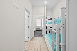 Bunk beds are in the hallway across from the bathroom