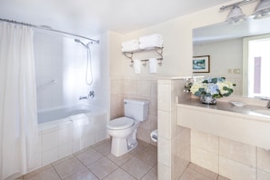 Refreshing bathroom with a spacious vanity, well-lit mirror, and modern fixtures for a spa-like experience.