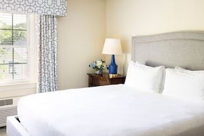 Elegant bedroom with a plush bed, warm lighting, and tasteful decor designed for ultimate comfort.