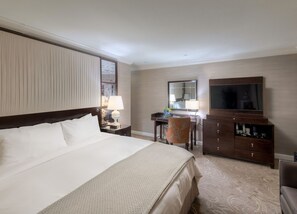 Spacious and serene bedroom retreat, where plush bedding and warm lighting create the perfect escape.