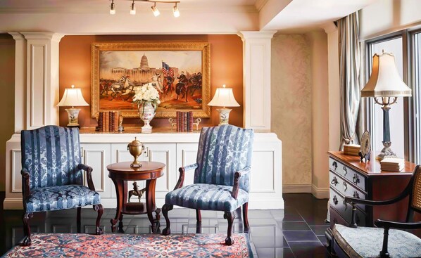 Timeless elegance in a refined sitting area, where classic furnishings and warm lighting create an inviting ambiance.