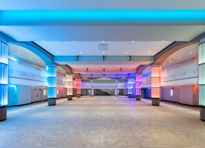 A breathtaking event space, illuminated with dynamic lighting and designed to transform any occasion into an unforgettable experience.
