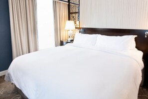 A serene escape, where plush bedding and soft lighting create the perfect space to unwind.