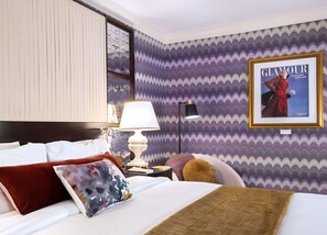 A bold and stylish retreat, where plush bedding meets vibrant patterns for a unique stay.