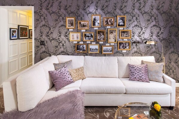 A cozy yet sophisticated space, designed for relaxation with soft hues and artistic touches.
