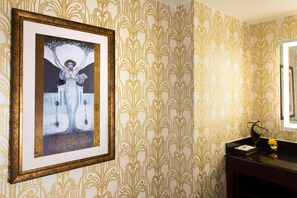 A touch of vintage elegance, with intricate wallpaper and framed art adding timeless charm.