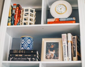 A thoughtfully curated bookshelf, blending literature, art, and timeless decorative pieces.