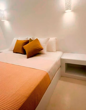 Cycladic experience in Paphos: Handmade Mykonos-style bed for a unique stay.