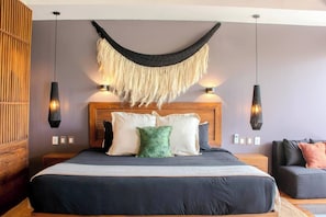 Comfy king bed with fluffy pillows, cozy loveseat, and handy outlets!